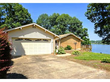 Charming lakeside home with an attached garage and a quaint wooden deck overlooking the water at 160 Quail Hollow Dr, Kings Mountain, NC 28086