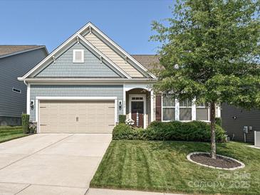 Charming home with a well-manicured lawn, two-car garage and inviting front porch at 177 Yellow Birch Loop, Mooresville, NC 28117