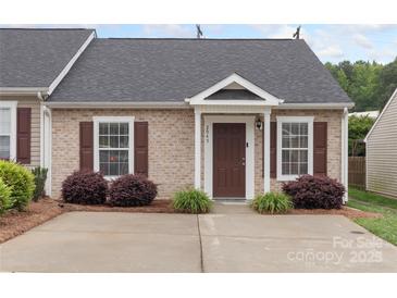 Charming brick townhome with a well-manicured front yard and a cozy covered entry at 2045 Pin Oak Pl, Cramerton, NC 28032