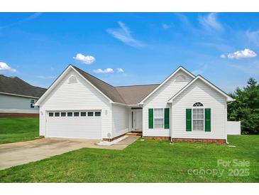 Charming single-story home with white siding, a manicured lawn, and an attached two-car garage at 2467 Hawk Ridge Dr, Gastonia, NC 28056