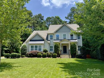 Charming two-story home with well-manicured lawn and lush landscaping at 6422 Northern Red Oak Dr, Mint Hill, NC 28227