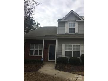 Charming home with gray siding, brick accents, and white trim on a cloudy day at 136 Mangum Cir, Mooresville, NC 28117