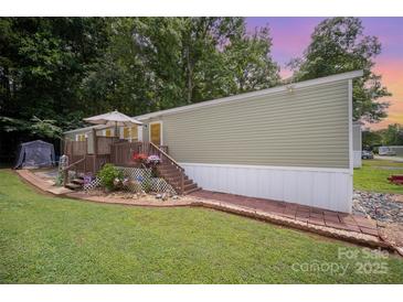 Charming single story home featuring a quaint front porch, manicured lawn and mature trees at 251 Birch Tree Rd, Clover, SC 29710
