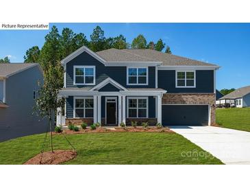 Charming two-story home featuring a blue exterior, complemented by a well-manicured lawn at 265 Miramar Dr, York, SC 29745