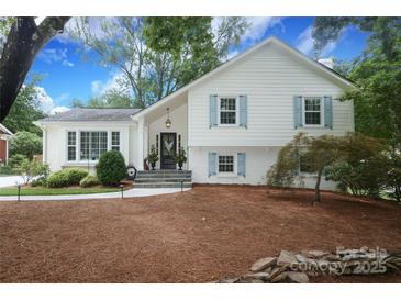Charming two-story home with blue shutters, landscaped yard, brick accents, and inviting front porch at 4126 Tyndale Ave, Charlotte, NC 28210