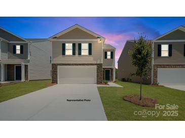 Charming two-story home featuring a two-car garage, stone accents, and well-manicured lawn at 432 Court House Ave, York, SC 29745
