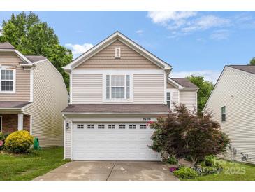 Charming two-story home with a white garage door and manicured landscaping at 9236 Clifton Meadow Dr, Matthews, NC 28105