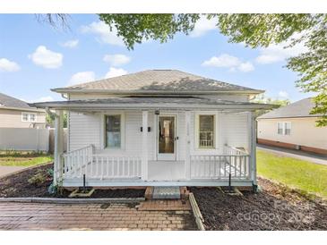 Charming home featuring a covered front porch, brick walkway, and white exterior at 1008 Valley St, Kannapolis, NC 28081