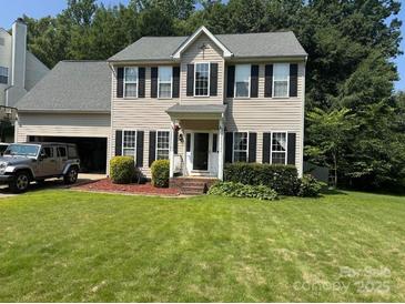 Traditional two-story home featuring a well-manicured lawn and an attached two car garage at 108 Shade Tree Cir, Fort Mill, SC 29715