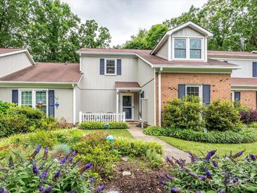 Charming townhome featuring a well-maintained yard, beautiful landscaping and blue shutters at 11120 Sevilla Ct, Charlotte, NC 28226