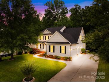 Beautiful two-story home with a manicured lawn and long driveway at 136 Pink Orchard Dr, Mooresville, NC 28115