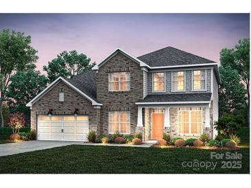 Charming two-story brick home with a well-manicured lawn and an attached two-car garage at 13904 Penbury Ln # 393, Charlotte, NC 28278