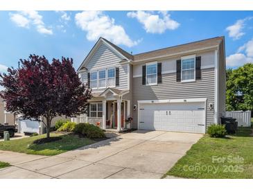 Charming two-story home with a well-manicured lawn, two car garage, and a welcoming front porch at 1398 Kent Downs Sw Ave # 52, Concord, NC 28027