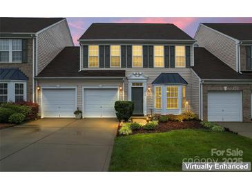 Charming two-story home featuring a two-car garage, well-manicured lawn, and beautiful landscaping at 1418 Skidaway Nw St # 427, Concord, NC 28027