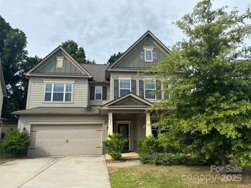 Charming two-story home with a two-car garage and well-maintained landscaping at 145 W Morehouse Ave, Mooresville, NC 28117