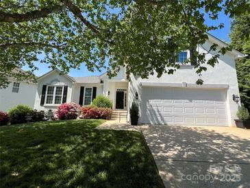 Charming two-story home with lush landscaping and a well-manicured lawn at 21218 Baltic Dr, Cornelius, NC 28031