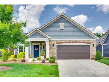 Charming home featuring a two-car garage, well-manicured lawn, and tasteful landscaping for curb appeal at 2261 Lincolnshire Ln, Waxhaw, NC 28173