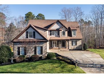 Charming two-story home with a combination of stone, wood, and stucco exterior at 394 Stonecliff Ln, Clover, SC 29710