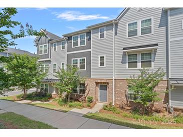 Charming townhouse with a gray exterior, brick accents, and well-maintained landscaping at 4008 Yucca Aly, Charlotte, NC 28217