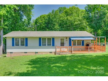 Charming single-story home featuring blue shutters and a welcoming front porch at 426 Valley St, Stanley, NC 28164