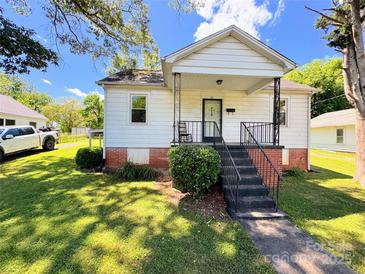 Charming single-story home featuring a cozy front porch and well-maintained lawn at 450 1St Se St, Hickory, NC 28602