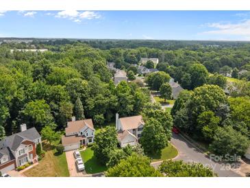 Beautiful aerial view of a neighborhood with tree lined streets showcasing Canopy 2025 For Sale sign at 9904 Brigstock Ct, Charlotte, NC 28269