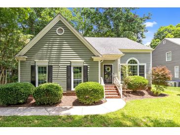 Charming single-story home featuring a well-maintained lawn and classic architectural details at 12524 Angel Oak Dr, Huntersville, NC 28078