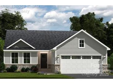 Charming one-story home features stone accents, gray siding, a two-car garage, and a welcoming front entrance at 147 Commerce Blvd # 0003, Lancaster, SC 29720