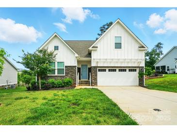 Charming two-story home with stone accents, a well-manicured lawn, and an attached two-car garage at 18619 Mainsail Ct, Lancaster, SC 29720