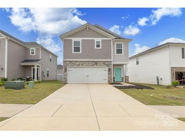 Charming two-story home with stone accents, attached garage, and a welcoming turquoise front door at 2116 Morgan Hills Dr, Albemarle, NC 28001