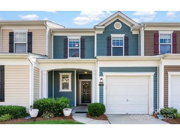 Charming townhouse with blue siding, a one-car garage, and a cozy front porch entrance at 237 River Clay Rd, Fort Mill, SC 29708