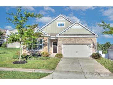 Charming single-Gathering home featuring stone accents, manicured lawn, and a two-car garage at 4333 Legacy Dr, Denver, NC 28037