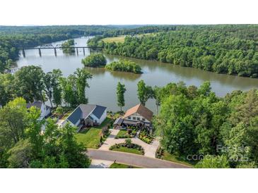 Stunning aerial view of waterfront homes with manicured lawns and beautiful landscaping overlooking the Catawba River at 5888 Wood Duck Way, Catawba, NC 28609