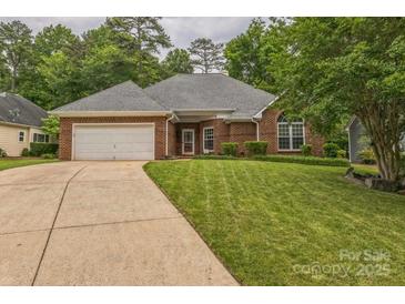 Charming single-story brick home featuring an attached two-car garage and well-maintained front lawn at 9137 Brightleaf Pl, Charlotte, NC 28269