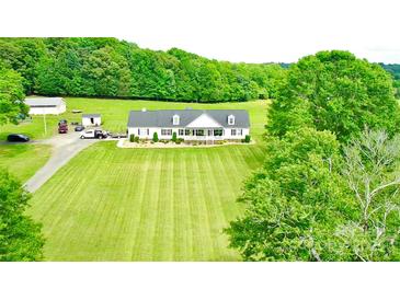 Expansive lawn and picturesque home nestled among lush green trees at 1238 Shinnville Rd, Cleveland, NC 27013