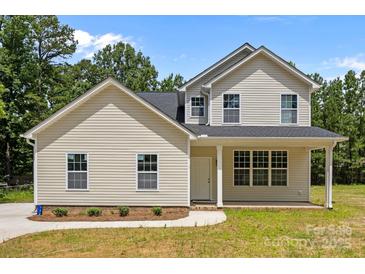 Charming new construction home features a welcoming front porch and a well-manicured lawn at 130 Aurora Blvd, Matthews, NC 28105