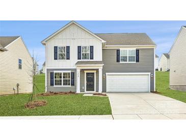 Charming two-story home with a two-car garage, blue shutters, and well-manicured lawn at 1530 Cottage Creek Dr, Bessemer City, NC 28016
