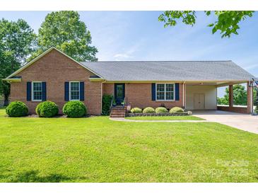 Single-story brick home with well-kept lawn, classic shutters, and a convenient covered carport at 233 Reliance Rd, Kings Mountain, NC 28086