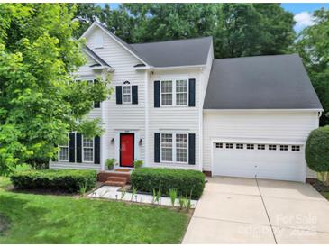 Charming two-story home boasts a well-manicured lawn, black shutters, and a vibrant red front door at 488 Saint George Rd, Fort Mill, SC 29708