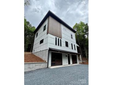 Modern two-story home showcasing white siding, dark window trim, and a two-car garage at 908 Apex Dr, Albemarle, NC 28001