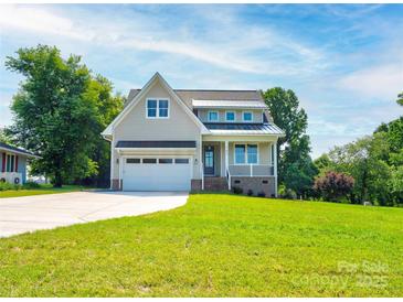 Charming two-story home featuring an attached two-car garage and landscaped front yard at 102 Starmount Dr, Kings Mountain, NC 28086