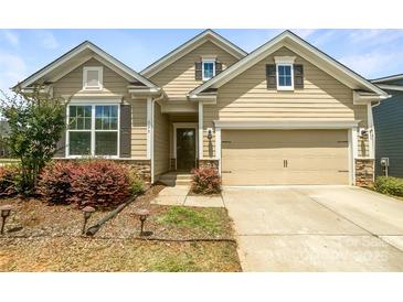 Charming home featuring a two-car garage, manicured landscaping, and stone accents at 103 Margo Ln, Statesville, NC 28677