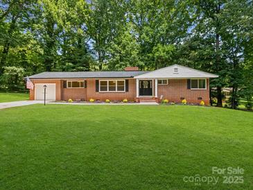 Charming brick home with a lush green lawn and beautiful landscaping at 1123 Timberlane Dr, Lincolnton, NC 28092