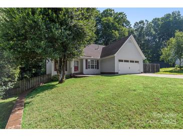Charming one-story home featuring a well-maintained lawn and attached two-car garage at 131 Canopy Ct, Mooresville, NC 28115