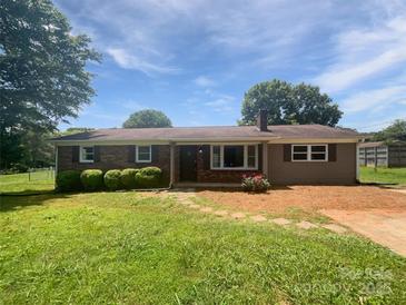 Charming single-story home with brick and vinyl siding, complemented by mature landscaping and a sunny front yard at 132 Windy Hill Rd, Statesville, NC 28625