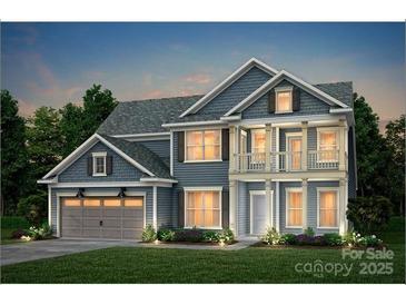 Charming two-story home with blue siding, covered porch and manicured lawn, perfect for suburban living at 13928 Penbury Ln # 399, Charlotte, NC 28278