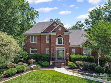Beautiful two-story brick home with mature landscaping and a well-manicured lawn on a sunny day at 2769 Independence Way, Gastonia, NC 28056