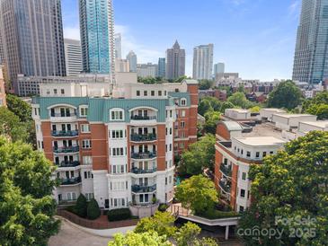 Attractive exterior shot of multi-story apartment building in downtown area with lush landscaping at 415 N Church St # 311, Charlotte, NC 28202