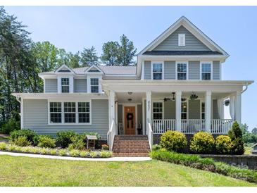 Charming two-story home featuring a welcoming front porch and landscaped front yard at 4237 Island Fox Ln, Denver, NC 28037