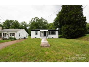 Charming single-story home with a well-maintained lawn and inviting front porch at 1017 W Fisher St, Salisbury, NC 28144